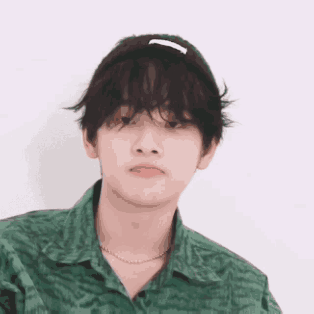 a man wearing a green shirt and a black headband