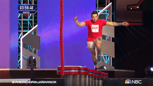 a man in a red shirt is jumping over a rope with the time of 03:59:40