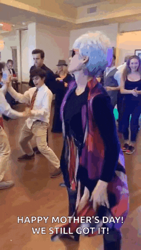 a woman is dancing in front of a group of people .