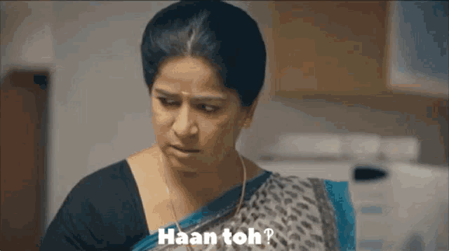 a woman in a blue and grey leopard print saree is saying haan toh
