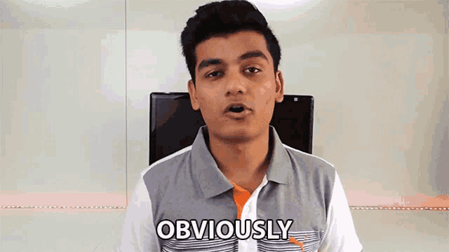 a man in a polo shirt says obviously in front of a monitor