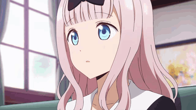 a girl with pink hair and blue eyes has a bow in her hair