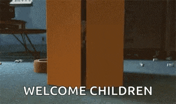 a cardboard box with the words `` welcome children '' written on it is sitting on the floor .