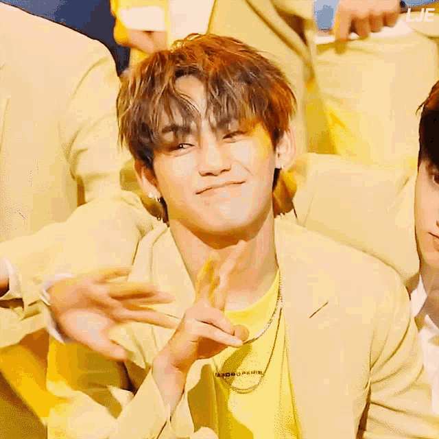 a man wearing a yellow jacket and a yellow shirt with the word lje on the bottom