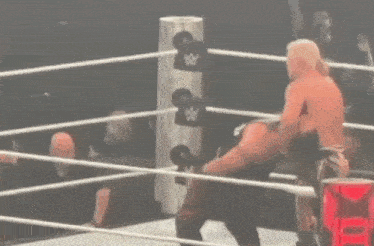 a man is laying on the ground in a boxing ring .
