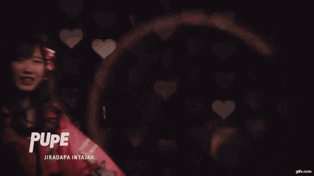 a girl in a pink jacket has the word pupe on her jacket