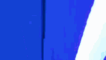 a person is standing in front of a blue curtain with a blue light shining on it .