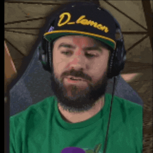 a man with a beard wearing headphones and a hat that says d lemon