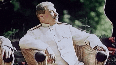 a man in a white uniform is sitting in a chair