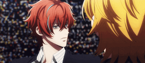 a man with red hair is standing next to another man with blonde hair