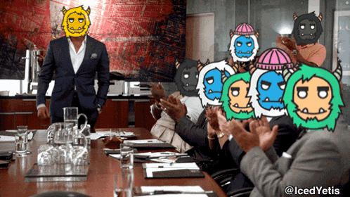a man in a suit stands in front of a group of people who are clapping and wearing monster masks