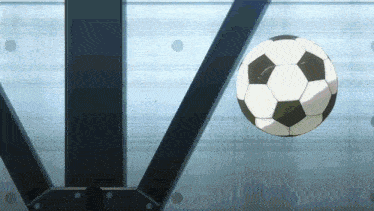 a soccer ball is flying through the air in front of a blue wall