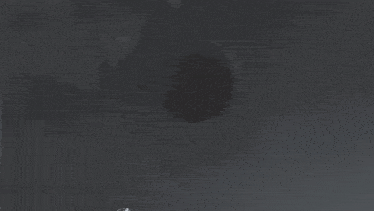 a black and white photo of a monster with a huge head