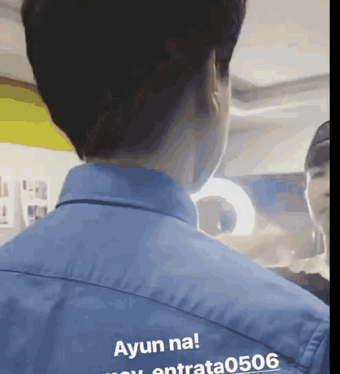 a man wearing a blue shirt that says ayun na