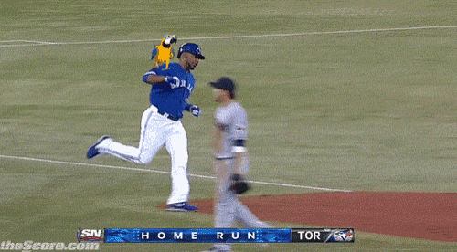 a blue jays player runs to first base during a game