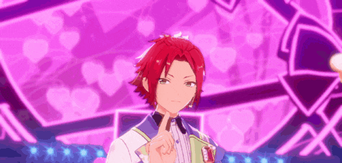 a boy with red hair is giving a peace sign in front of a purple background with hearts .