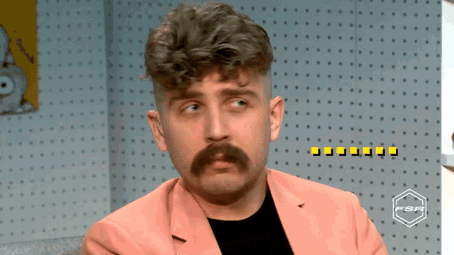 a man with a mustache is wearing a pink jacket with the fsr logo in the corner