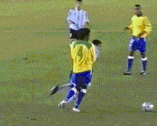 soccer players on a field with one wearing a yellow jersey with the number 2 on it