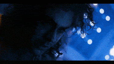a close up of a man 's face in a dark room