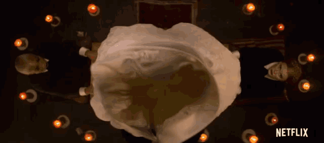 a netflix ad shows a woman in a wedding dress surrounded by lit candles