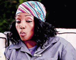 a woman wearing a bandana and a jacket says wow .