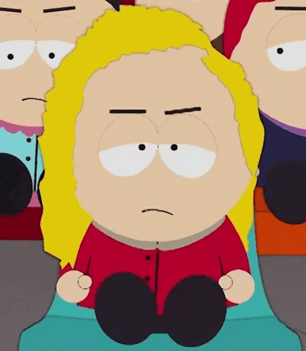 a cartoon character with blonde hair is sitting in front of a group of other characters