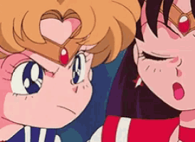 a couple of anime characters are standing next to each other and one of them has a heart on her face .