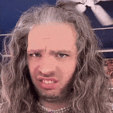 a man with long hair is making a funny face .