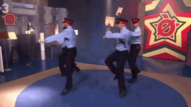 a group of police officers are dancing in front of a star with the number 3