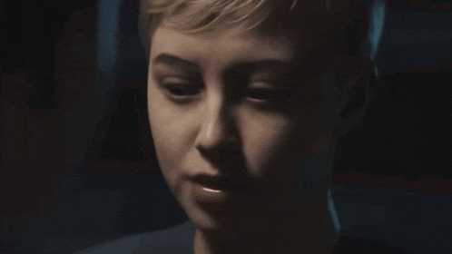 a close up of a person 's face with a dark background
