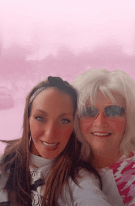 two women posing for a picture with one wearing sunglasses and the other a headband