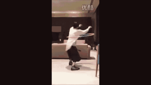 a person is playing with a hula hoop in a living room .