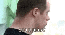a man is asking for 500 dollars while looking down at something .