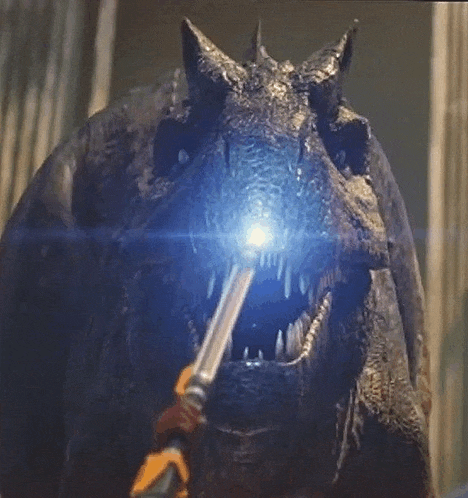 a close up of a dragon with a light coming out of it 's mouth