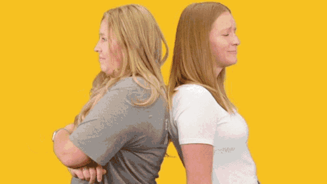 two women are standing back to back with the words good job written on their backs