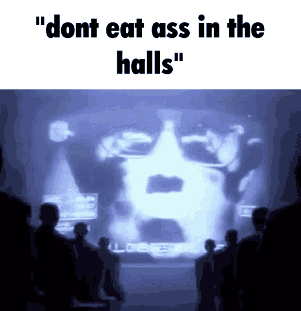 a group of people standing in front of a screen that says " do n't eat ass in the halls "