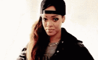 a woman wearing a baseball cap and a leather jacket is looking at the camera .