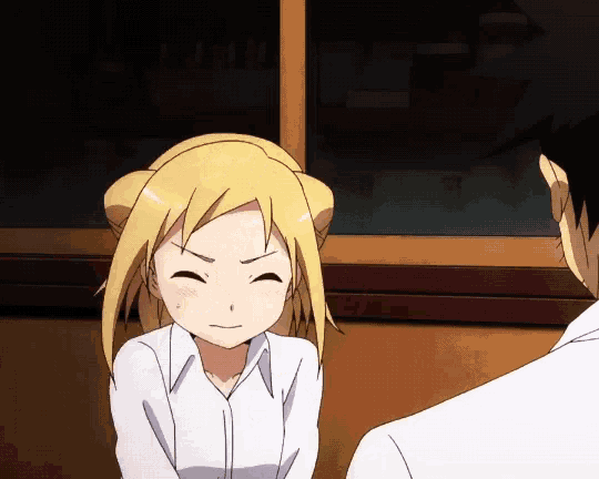 a girl with blonde hair is smiling and looking at a man in a white shirt