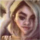 a close up of a woman 's face wearing a hoodie