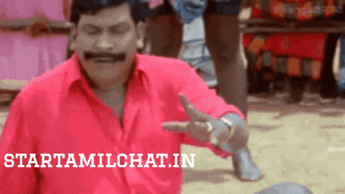 a man in a red shirt is pointing at something with the words starttamilchat.in written below him