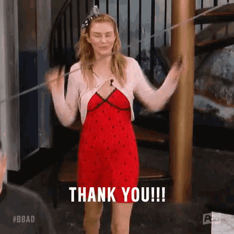 a woman in a red dress is standing in front of a spiral staircase holding a string and saying `` thank you '' .