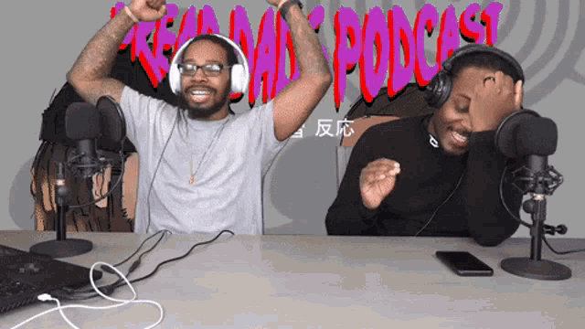two men wearing headphones are sitting in front of microphones with the word podcast written in red