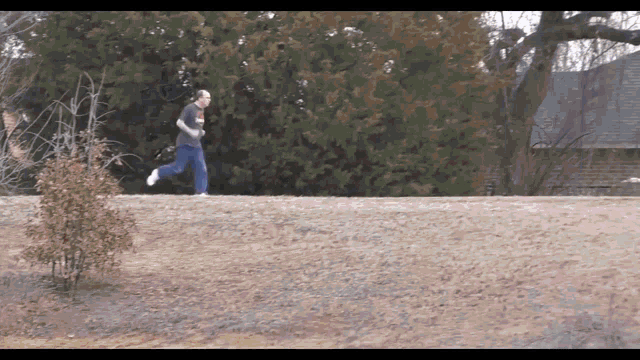 a man running on a hill wearing a t-shirt that says ' chicago bears ' on it