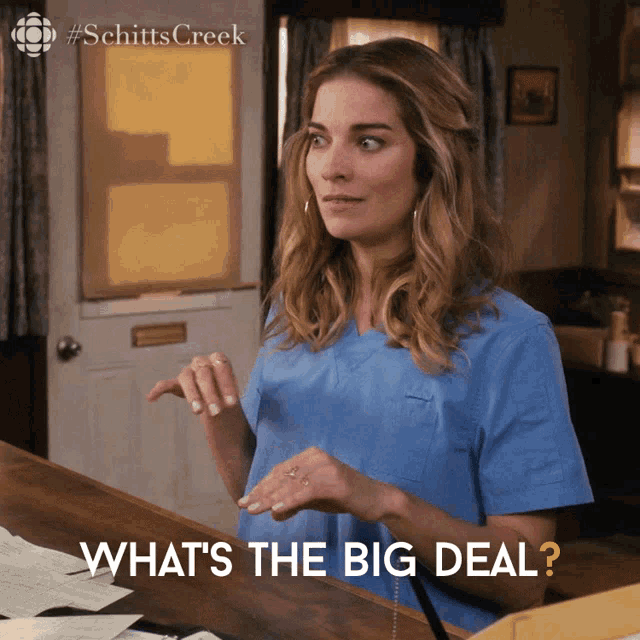 a woman in a scrub top is asking what 's the big deal