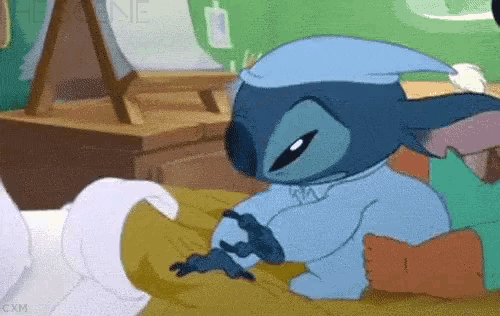 a cartoon character is laying on a bed wearing a night cap
