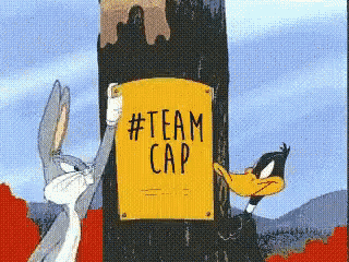 bugs bunny and daffy duck are standing next to a yellow sign that says #team cap