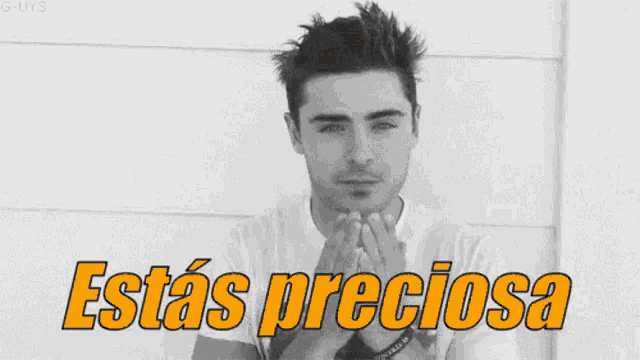 a black and white photo of a man with his eyes closed and the words estas preciosa written on the bottom .