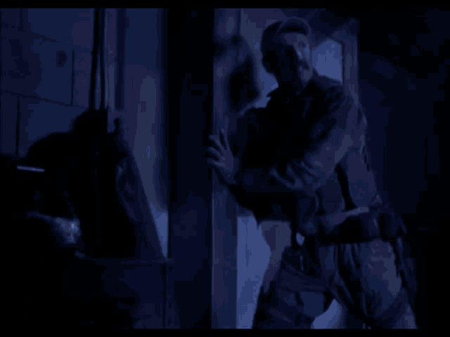 a man standing in a dark room with the words assblasters written in white