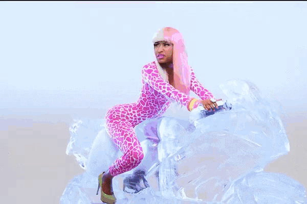 a woman in a pink leopard print jumpsuit is riding a motorcycle made of ice