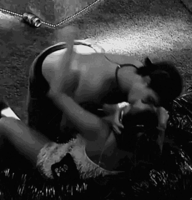 a black and white photo of two women kissing